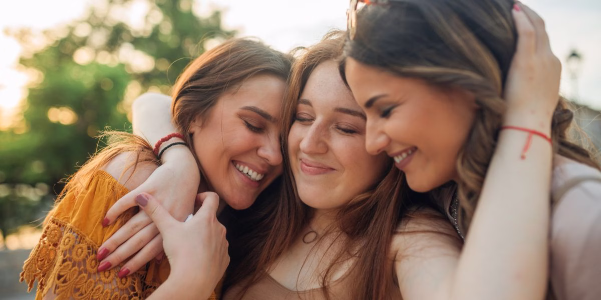 Mom with daughters hugging, emotionally preparing for launch