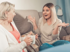 Mother and teenage daughter smiling and talking together — a warm moment that captures slowing down and building connection during the teen years.